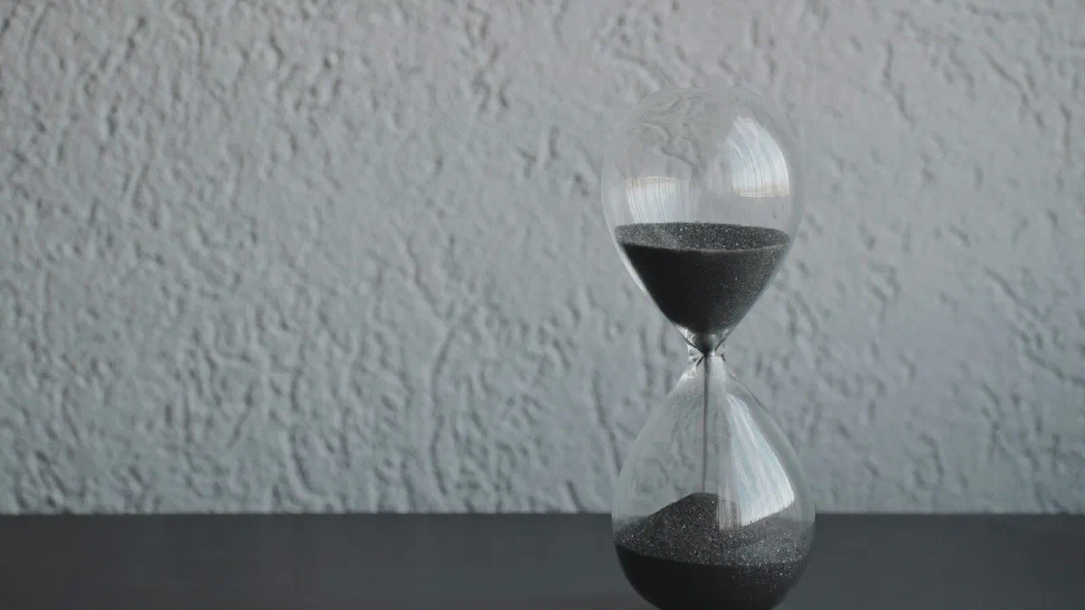 A clear glass hourglass with sand running through it